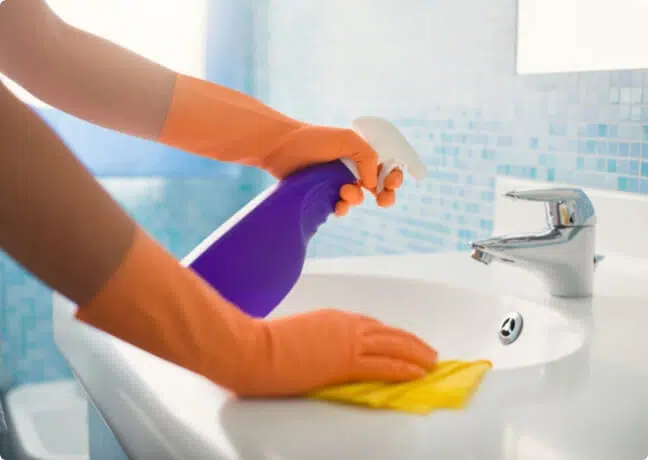 Independent local cleaner finishing a kitchen — the same work booked monthly with an independent costs $1,440-$2,160 per year, vs $7,228-$9,360 in the subscription-app trap