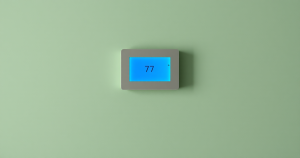 Modern wall thermostat set to cooling on a bare wall