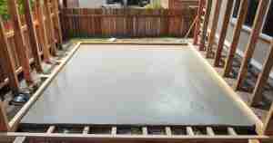 Freshly poured smooth concrete slab with wooden forms