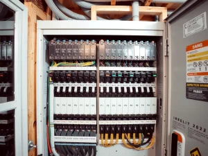 Electrician inspecting a home electrical panel
